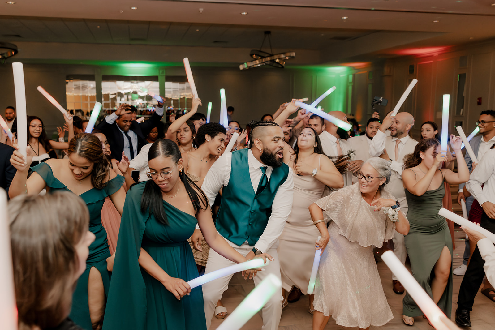 guests dance with light ropes during the classy wedding reception