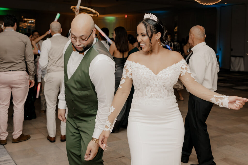 bride and groom dance with their wedding guests 