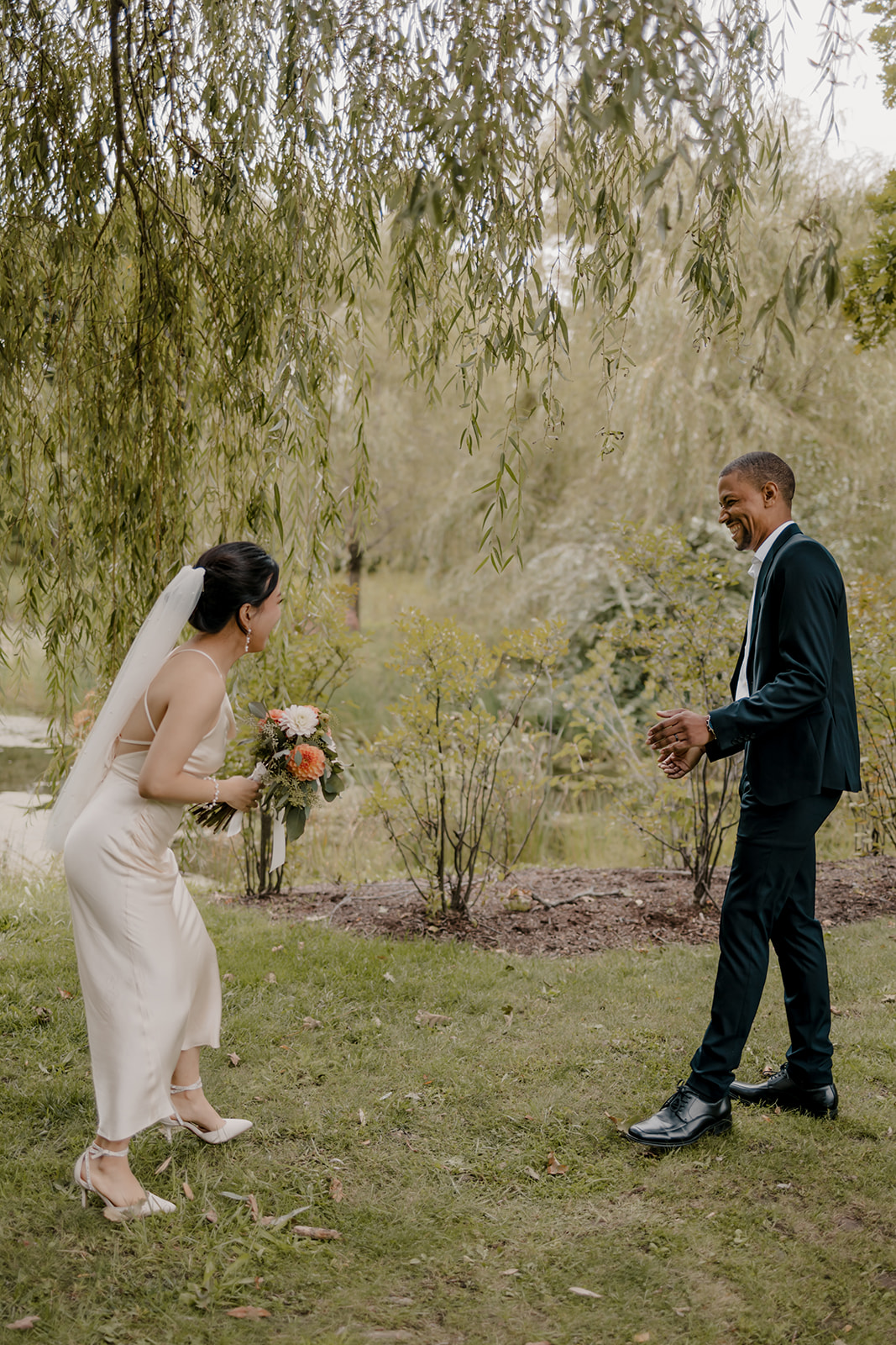 Stunning bride and groom share candid moments during their first look photos