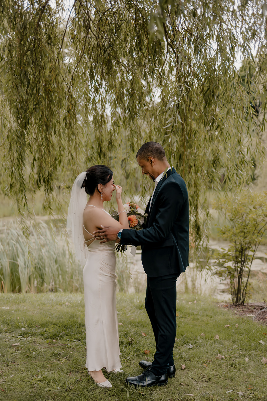 Stunning bride and groom share candid moments during their first look photos