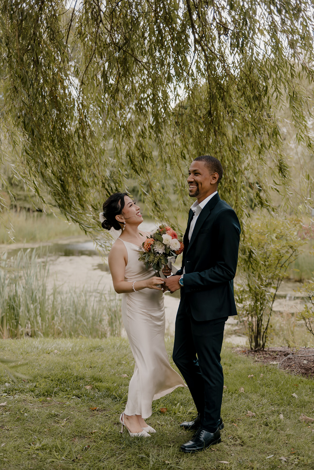 Stunning bride and groom share candid moments during their first look photos