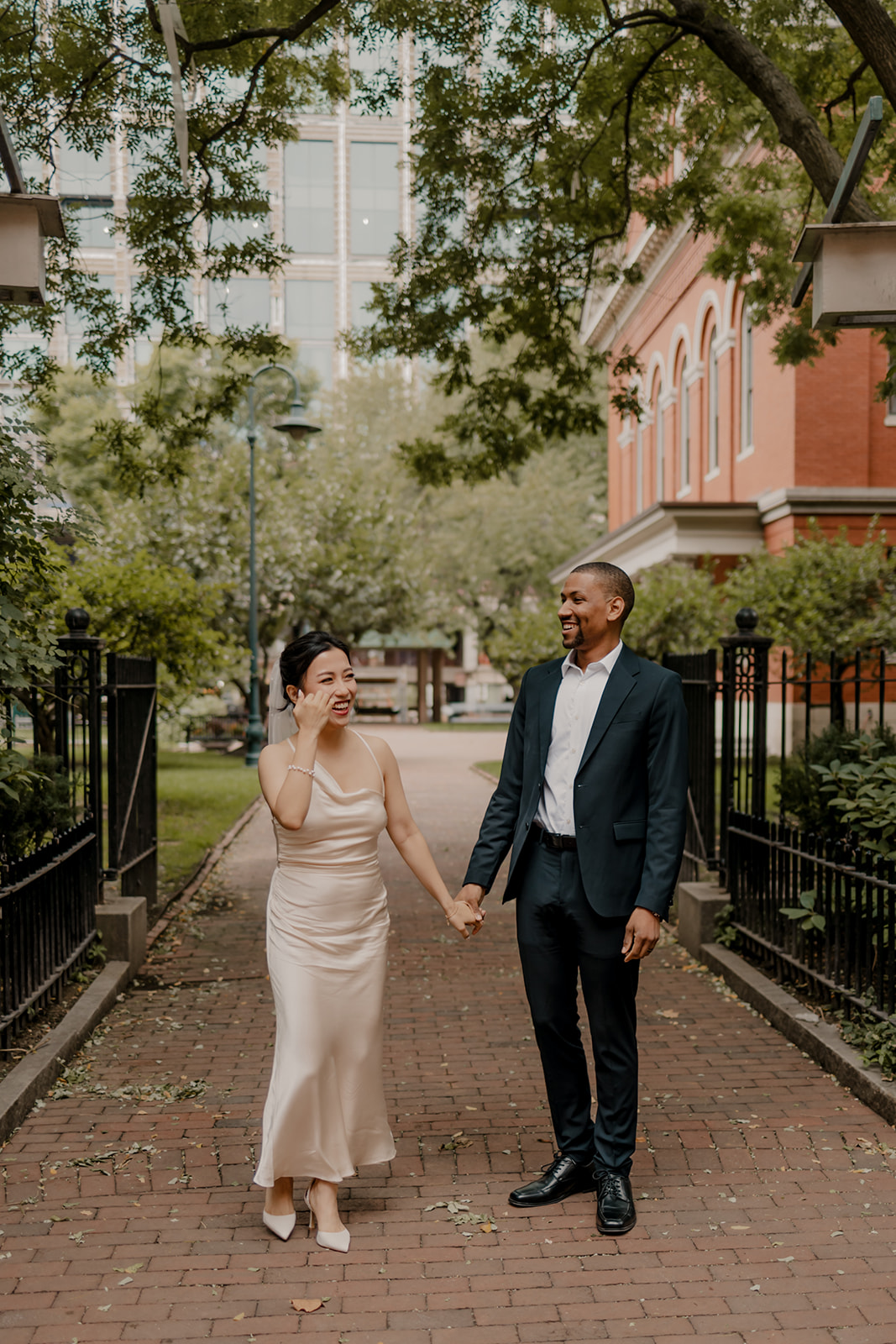 stunning couple walk in the city after their dreamy elopement day