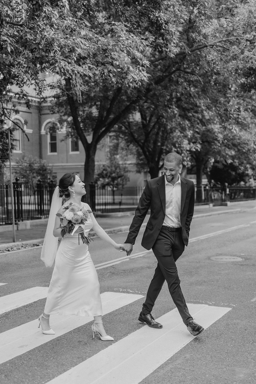 stunning couple walk in the city after their dreamy elopement day