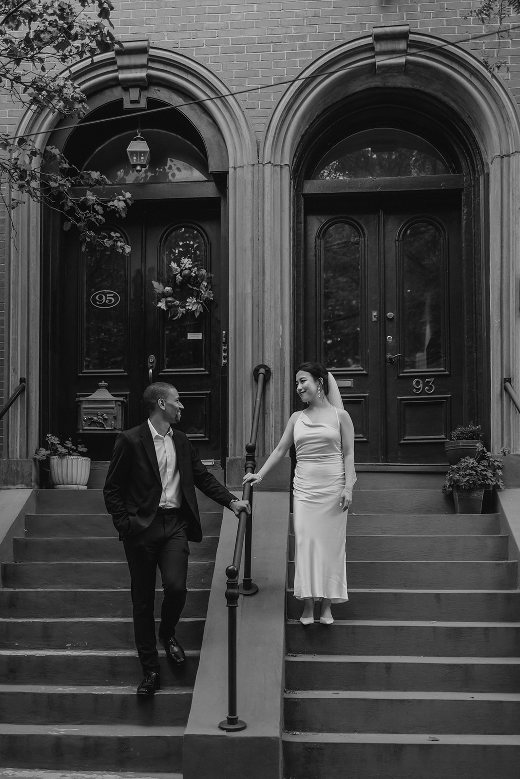 couple pose on the steps of a classic Boston townhouse