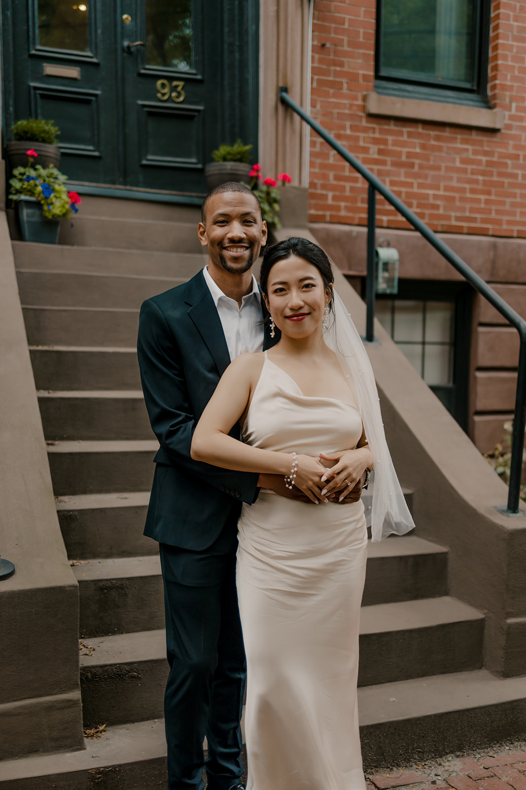 couple pose on the steps of a classic Boston townhouse