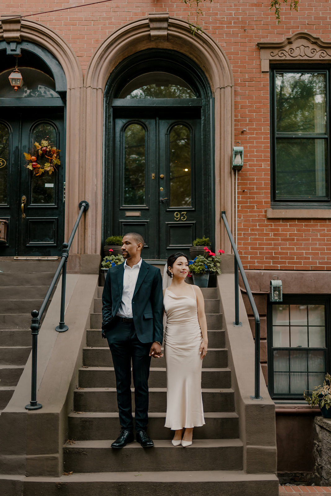 couple pose on the steps of a classic Boston townhouse