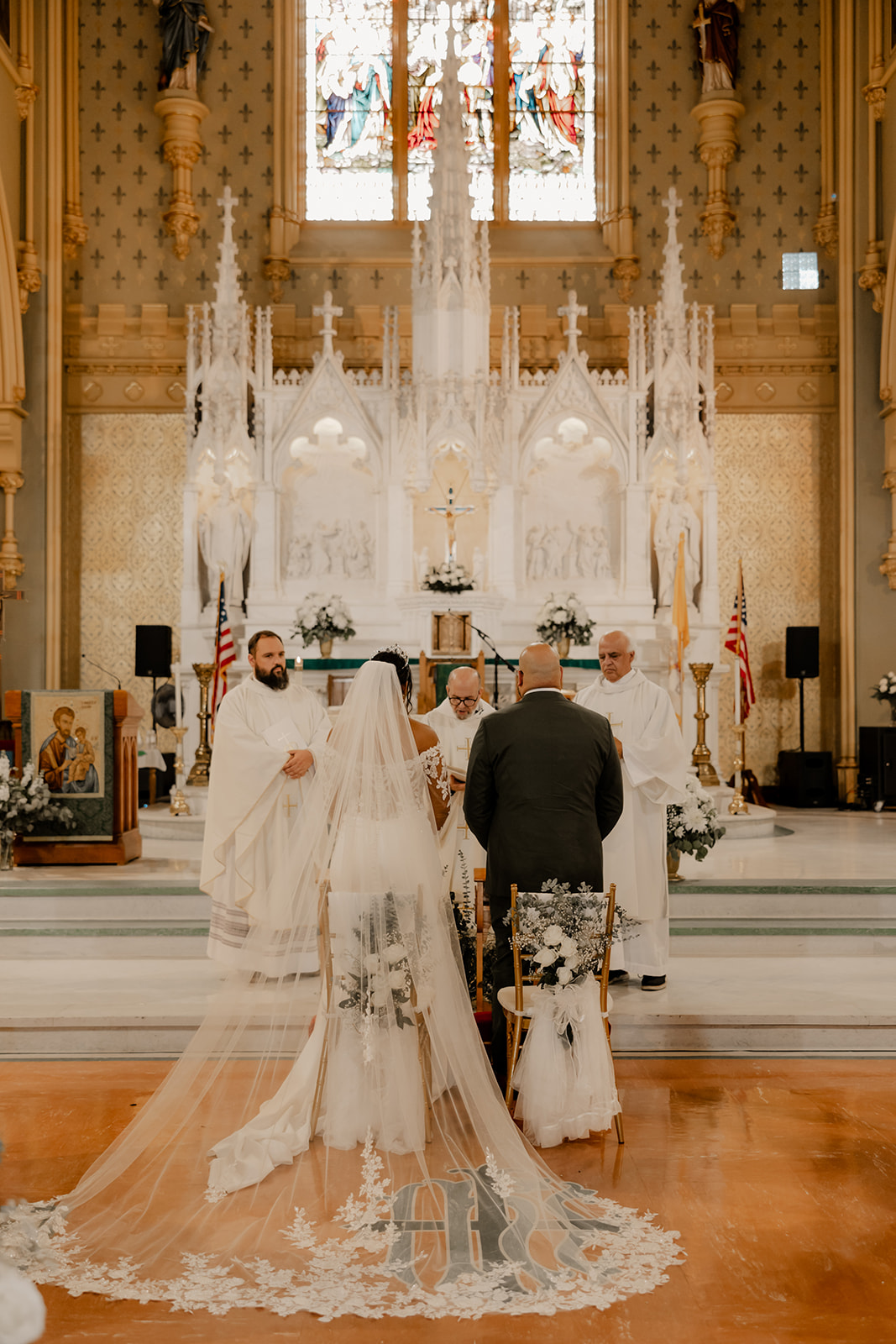 bride and groom stand together during their classy Boston church wedding ceremony