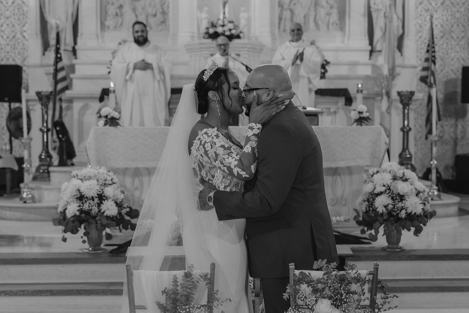 bride and groom share a kiss during their classy Boston church wedding ceremony