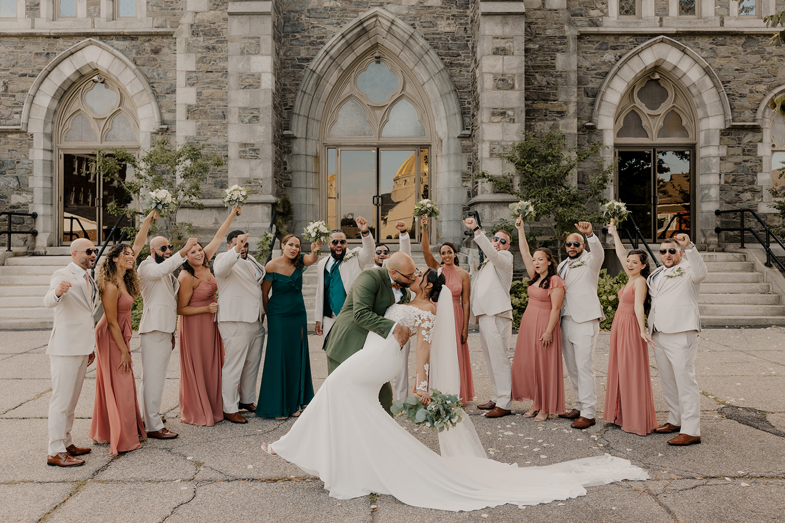 bride and groom share a kiss in front of the classy Boston church wedding venue