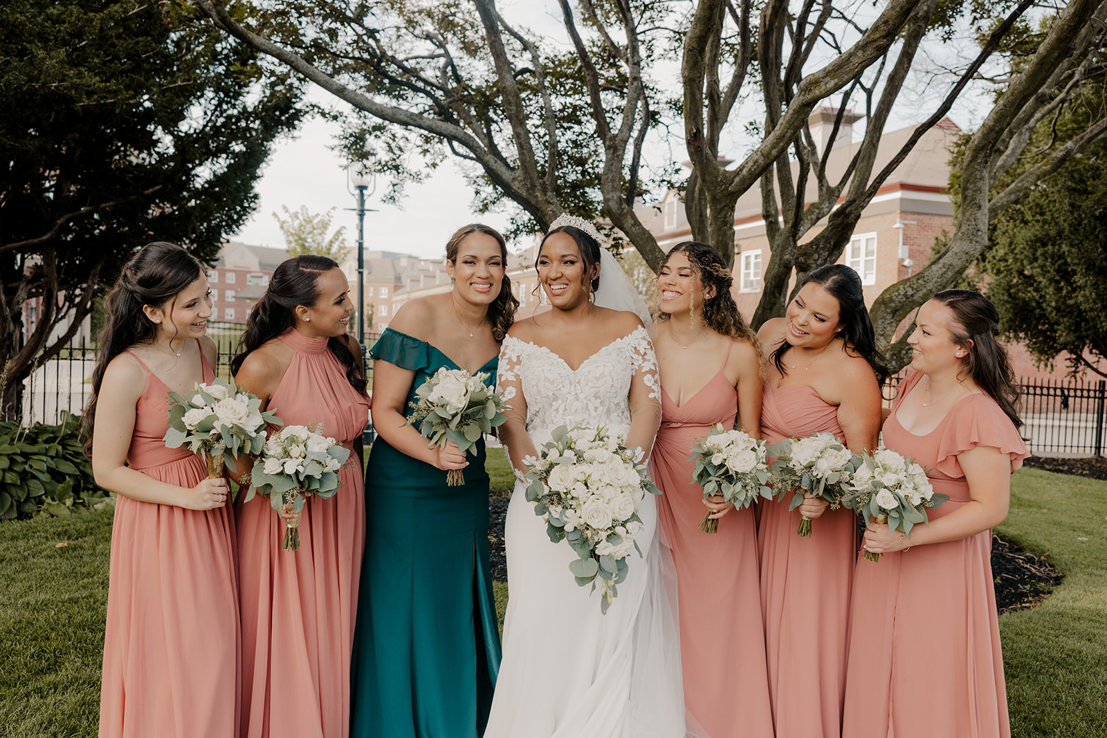 bride poses with her bridesmaids after her dreamy New England wedding day