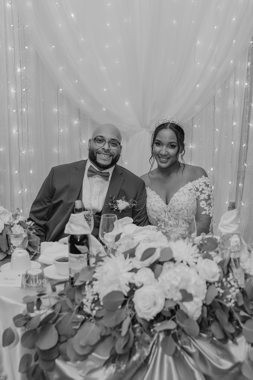 bride and groom sit together at their dreamy reception table 