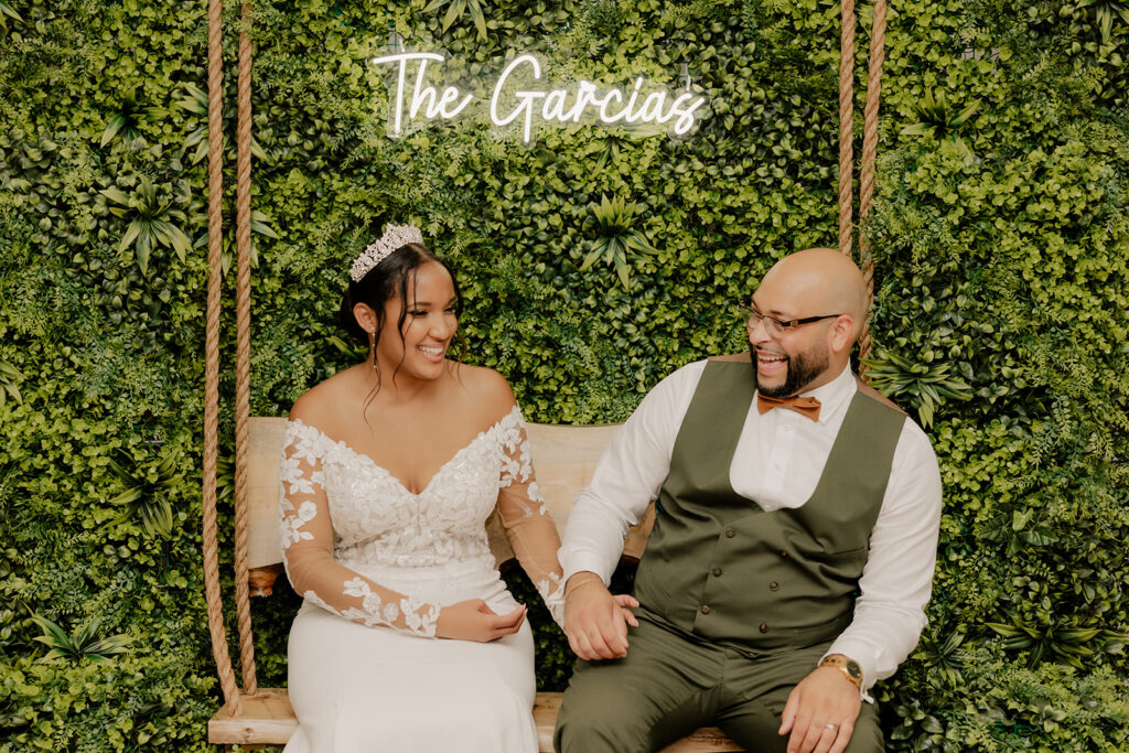 bride and groom sit on their swing together 