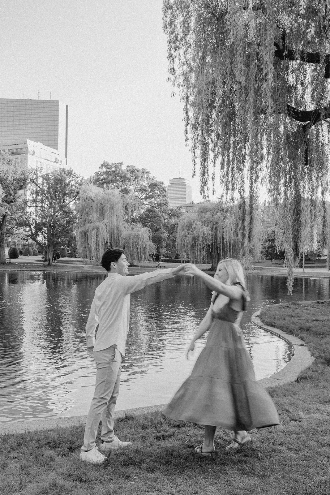 couple pose under weeping willows during their Boston engagement photos learn how to prepare for romantic engagement photos here!