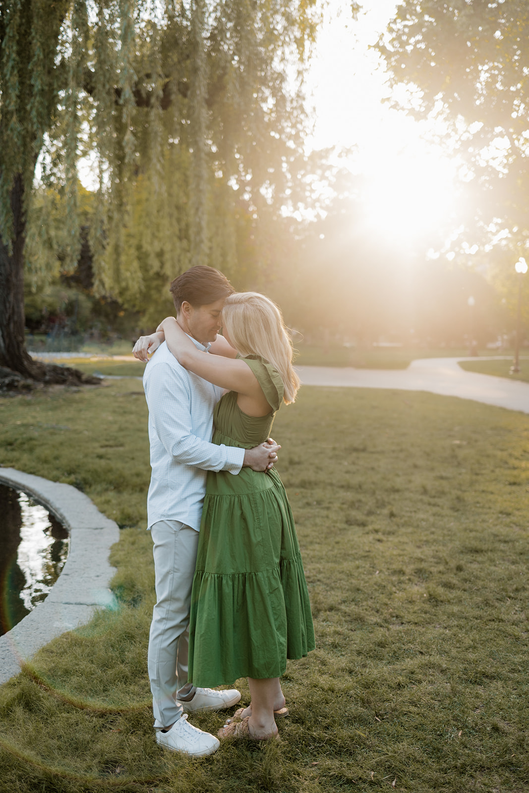 couple pose under weeping willows during their Boston engagement photos learn how to prepare for romantic engagement photos here!