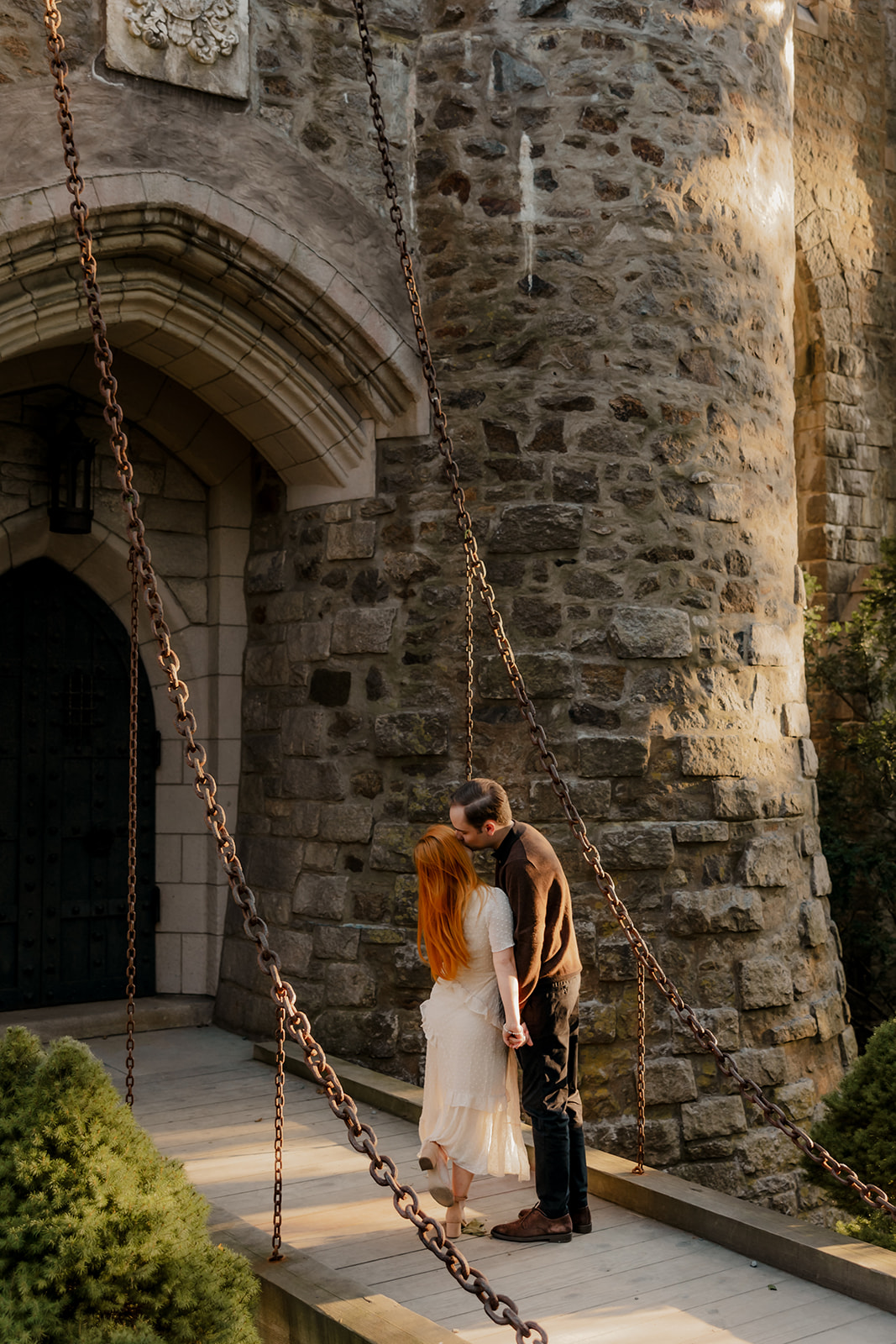 beautiful couple pose outside the Hammond castle during their Massachusetts engagement photoshoot