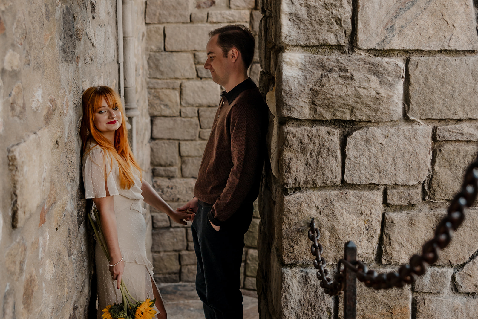 stunning couple pose in the Hammond Castle walkways during their New England engagement photos 