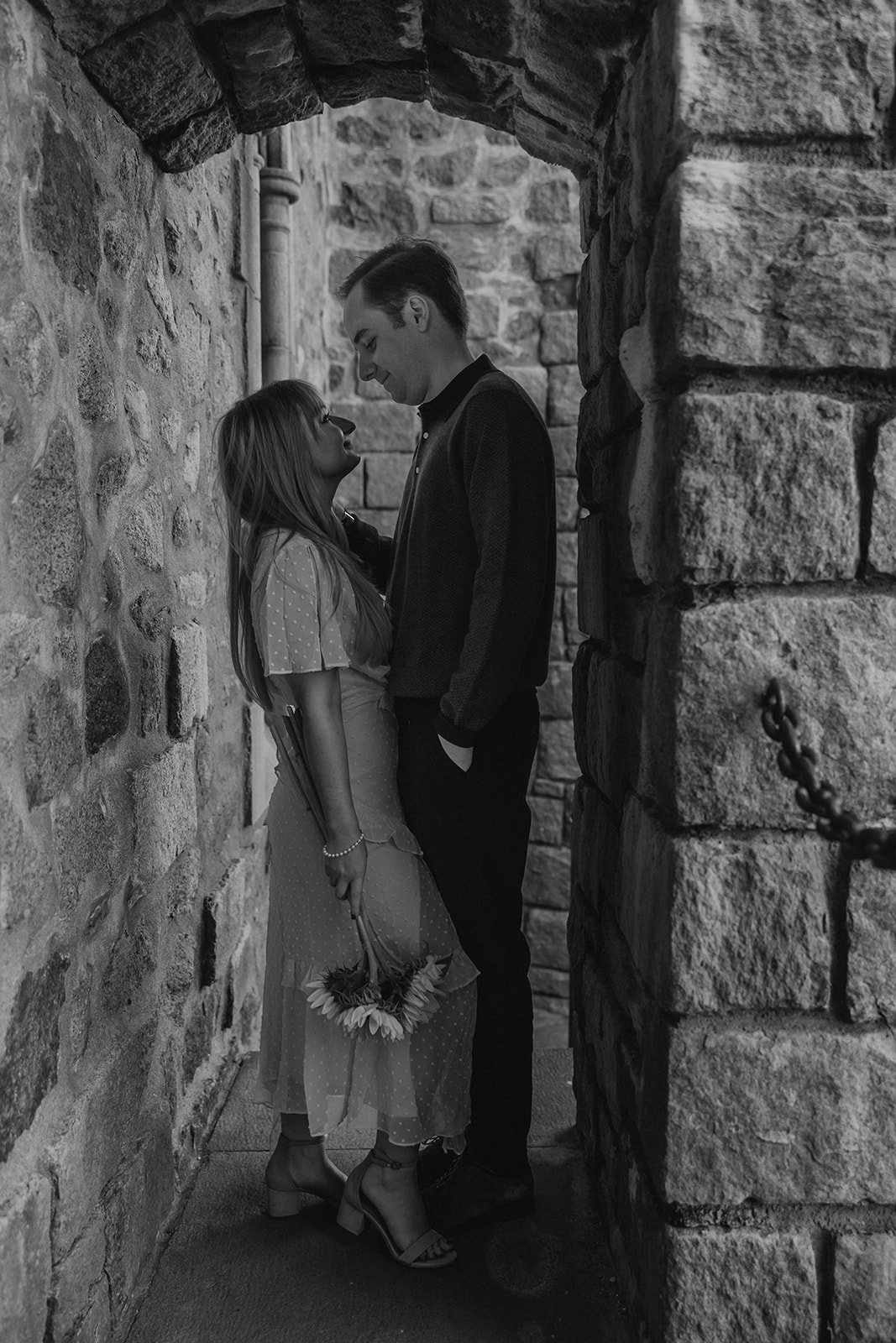 beautiful couple pose outside the Hammond castle during their Massachusetts engagement photoshoot