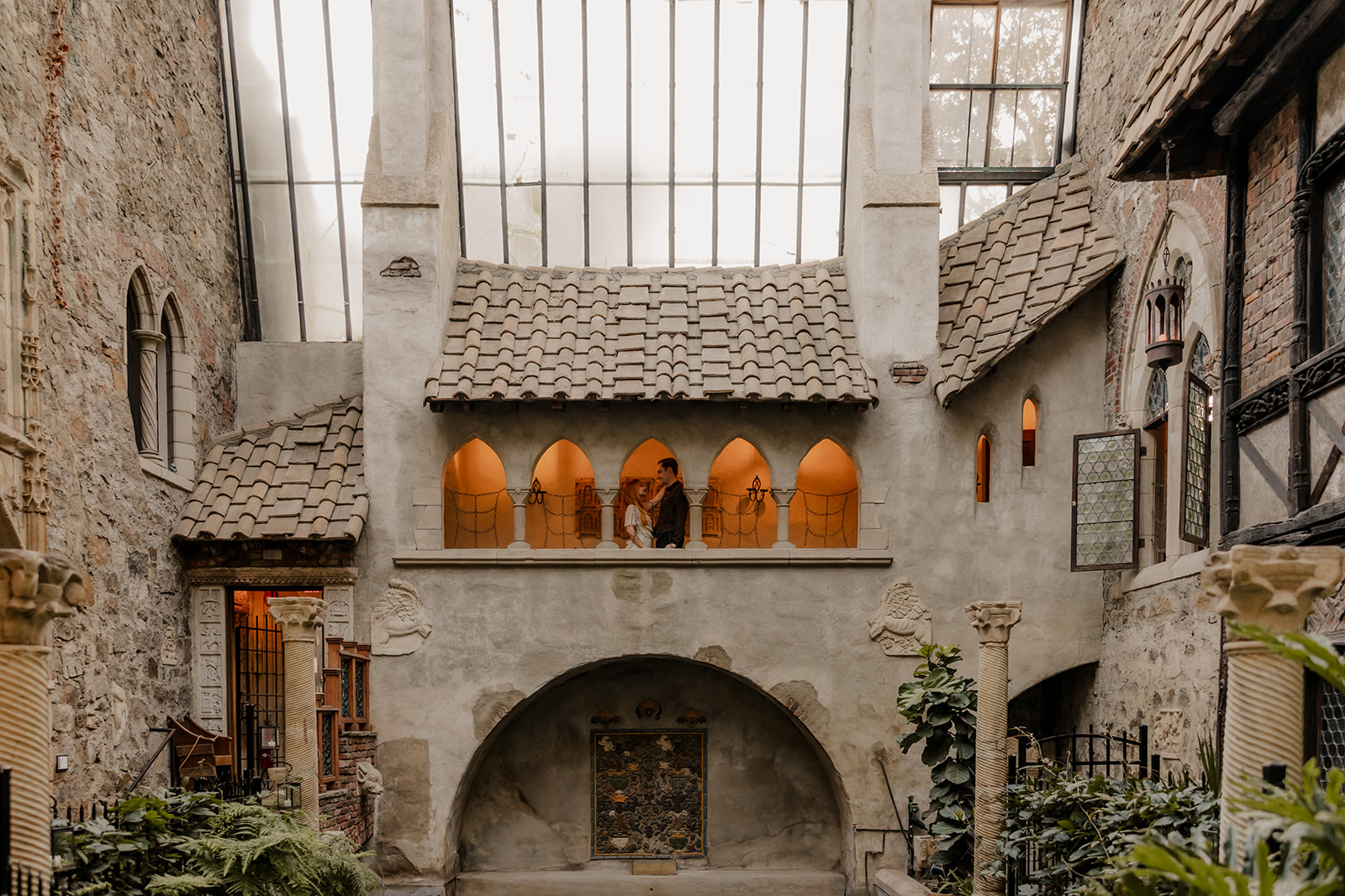 stunning couple pose on the balcony at Hammond castle during their romantic engagement photoshoot 