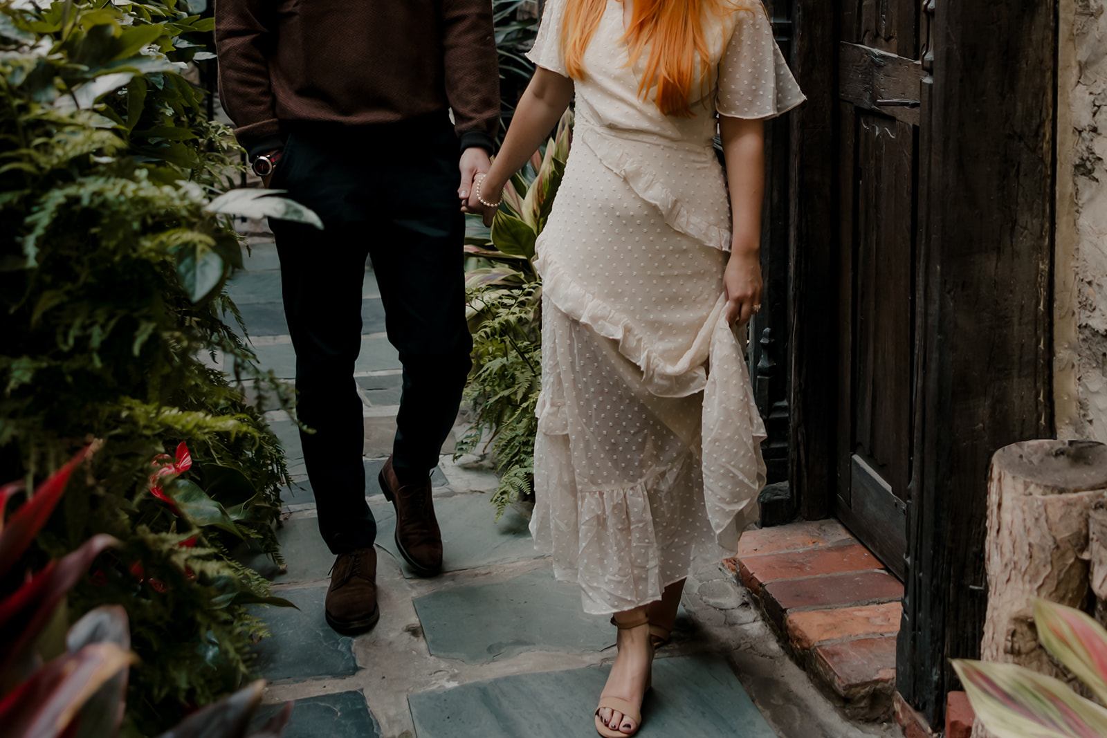 couple walk through the castle garden 