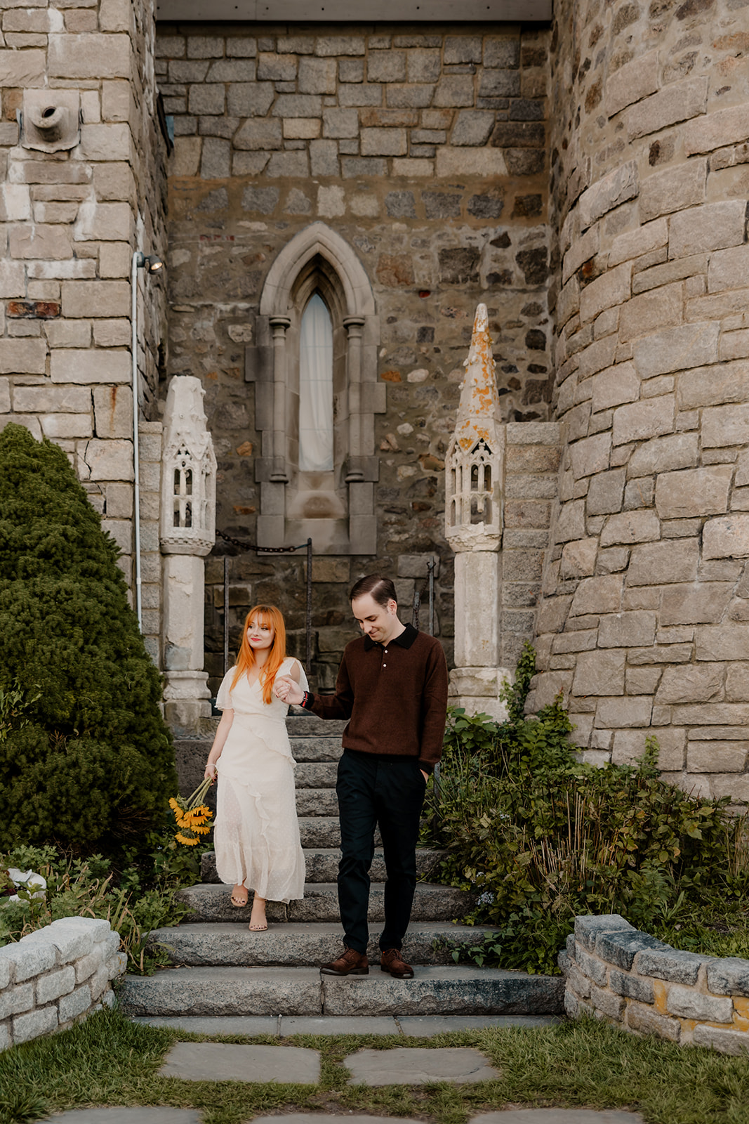 beautiful couple pose outside the Hammond castle during their Massachusetts engagement photoshoot