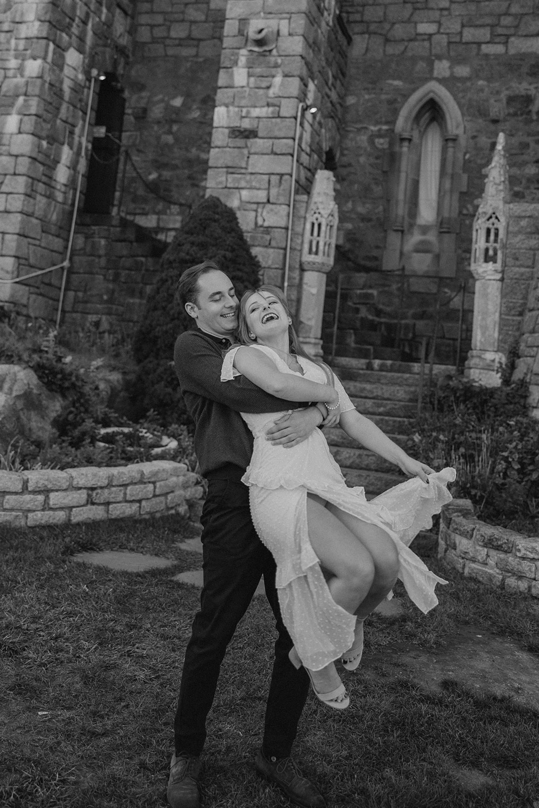 beautiful couple pose outside the Hammond castle during their Massachusetts engagement photoshoot