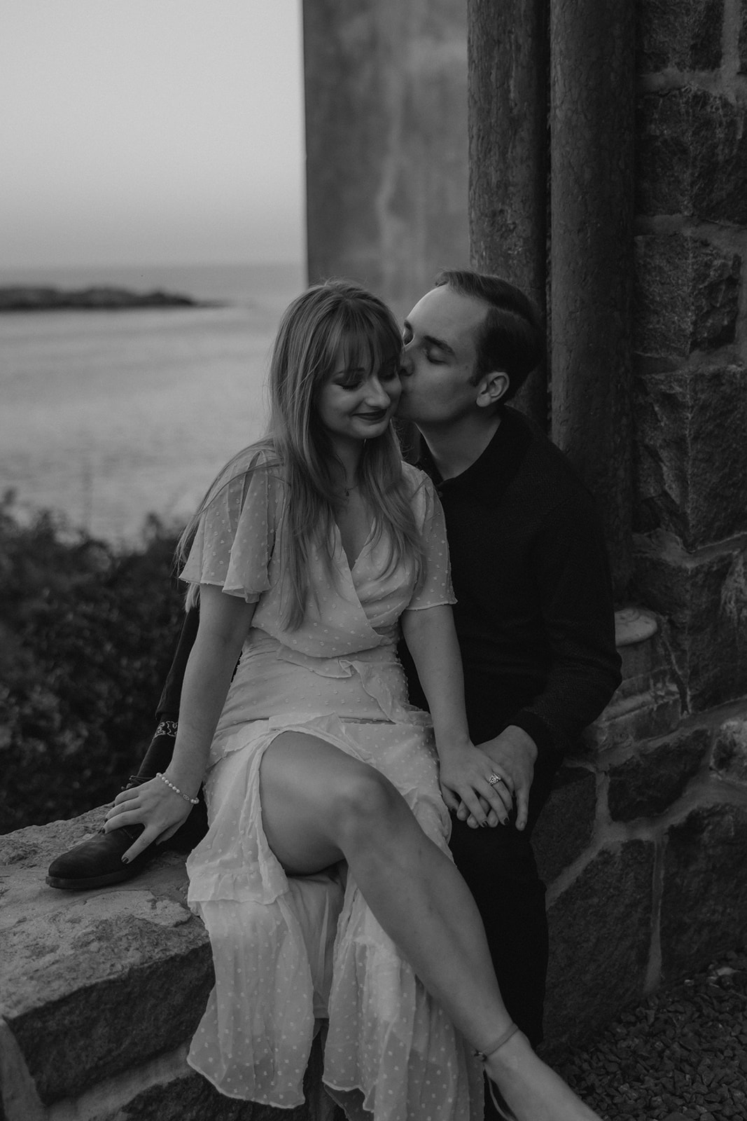 stunning couple pose on the balcony at Hammond castle during their romantic engagement photoshoot 