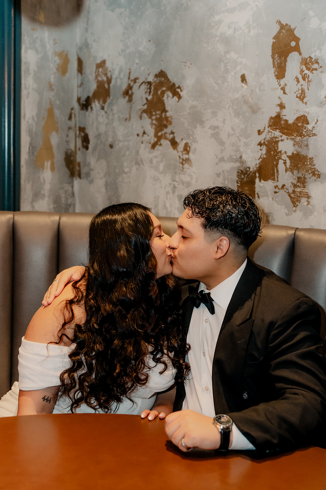 beautiful couple pose together in a Boston restaurant