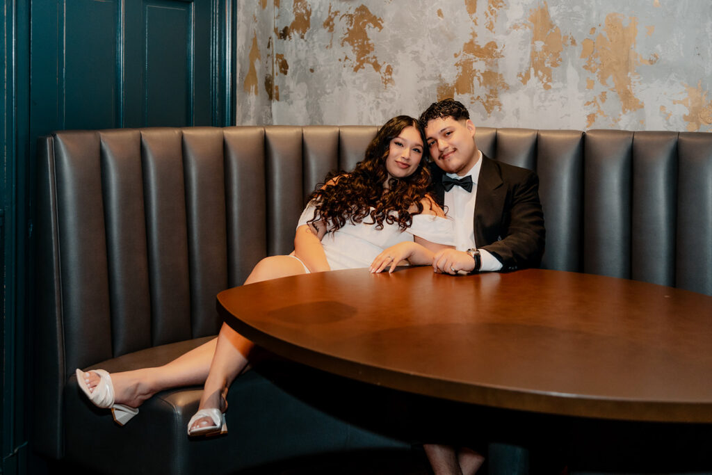 beautiful couple pose together in a Boston restaurant 