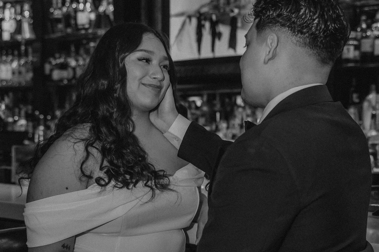 beautiful couple pose together in a Boston bar