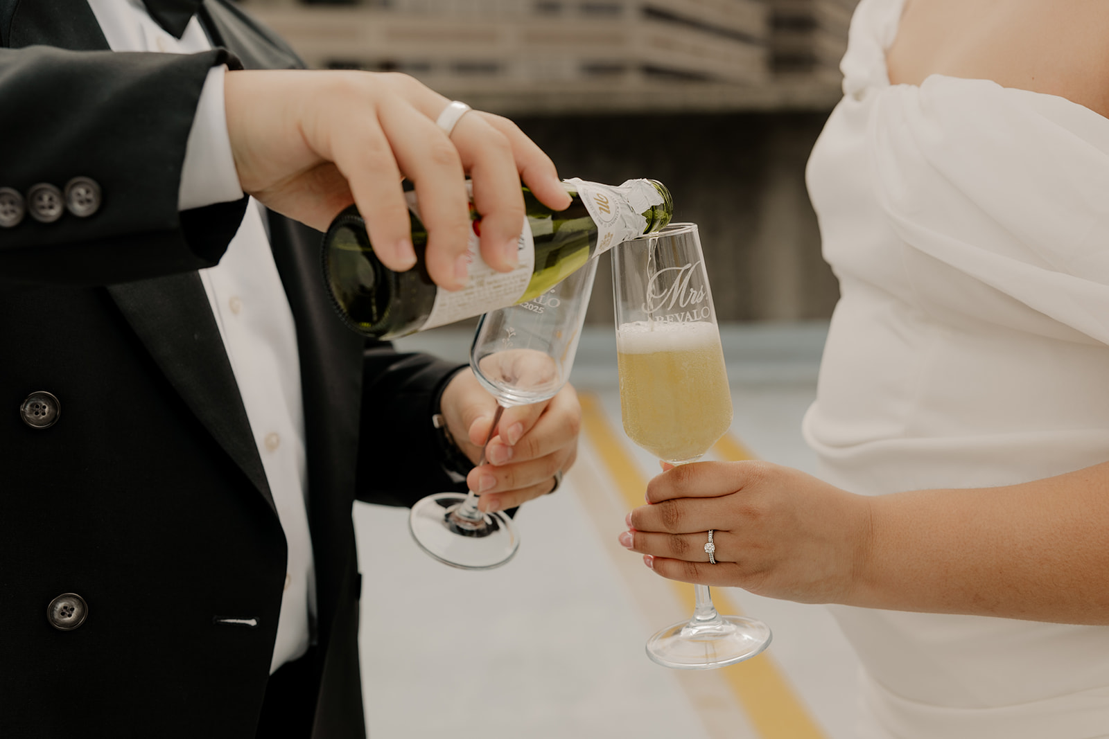 couple share champagne during their Boston engagement photoshoot