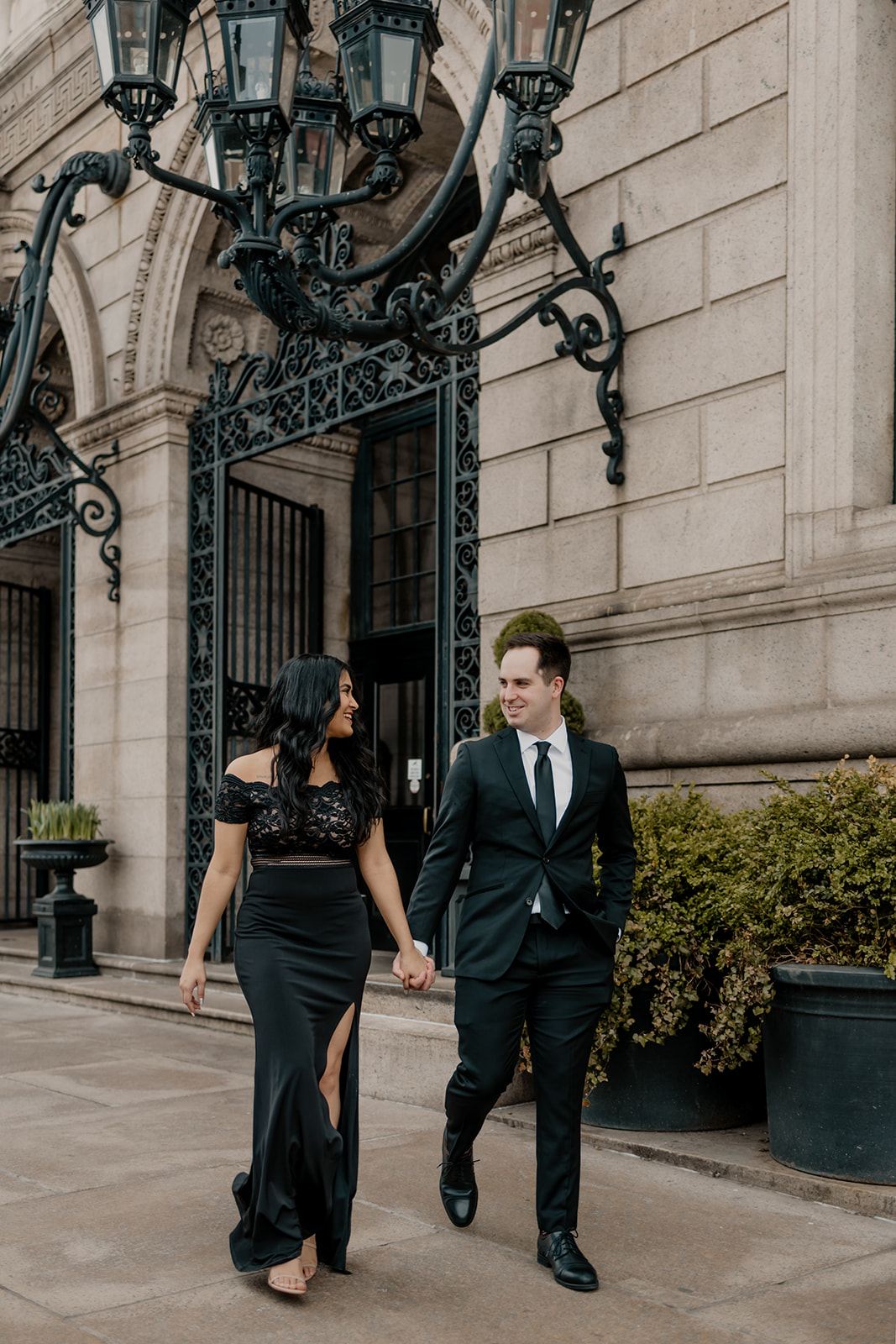 beautiful couple walk together in Boston during their dreamy engagement photoshoot