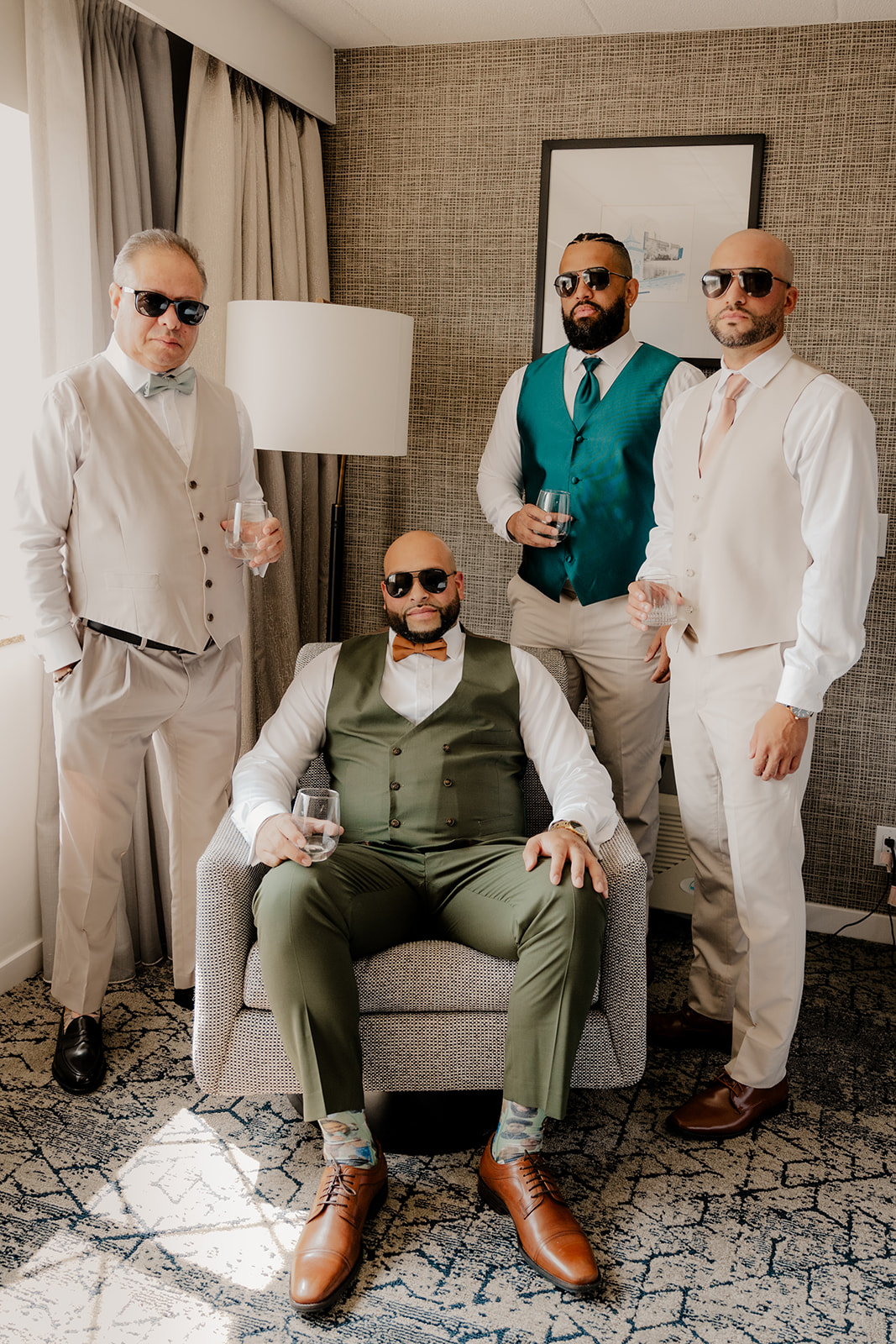 groom poses with his groomsmen before his big wedding day 