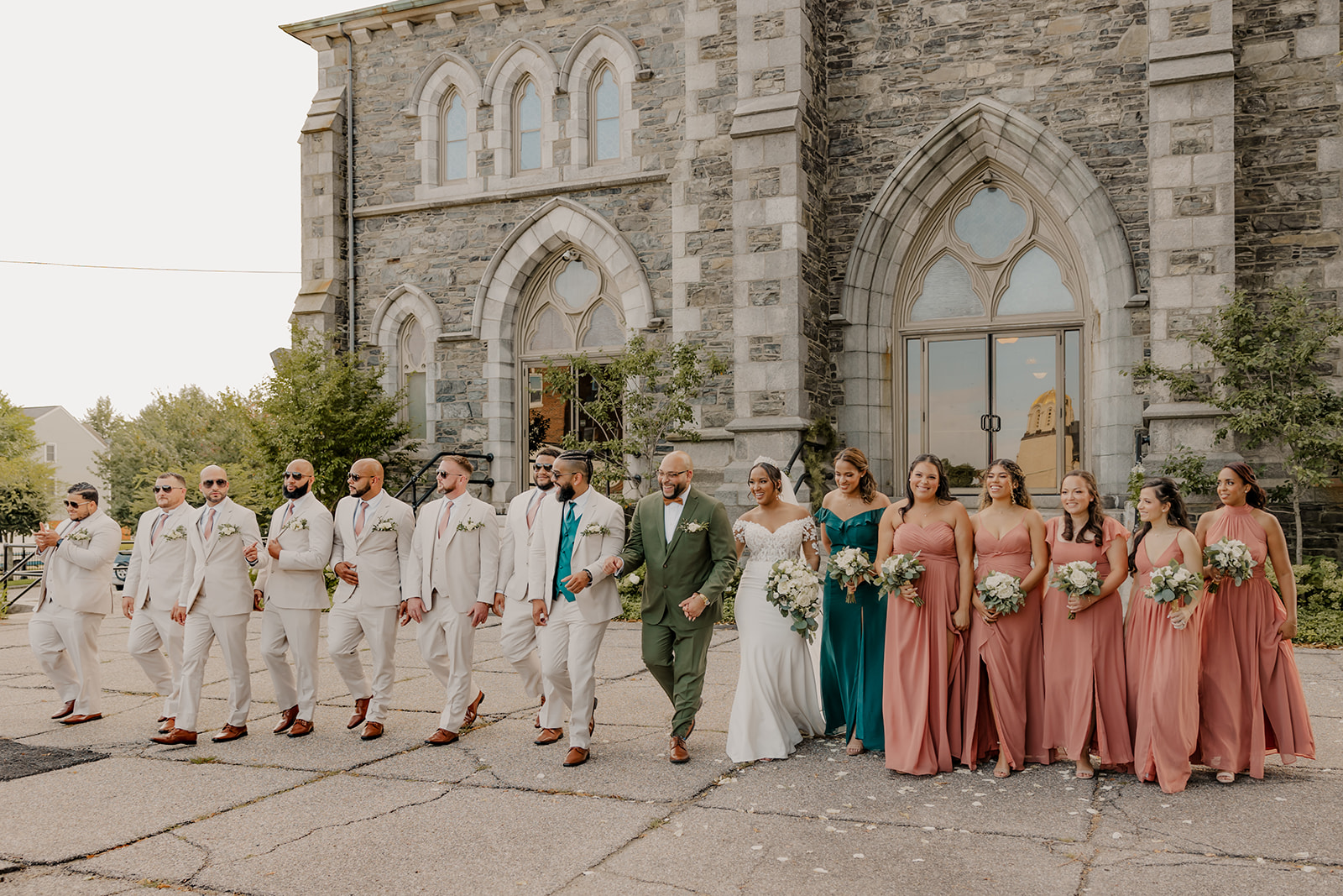 the wedding party poses outside the classy New England church wedding venue