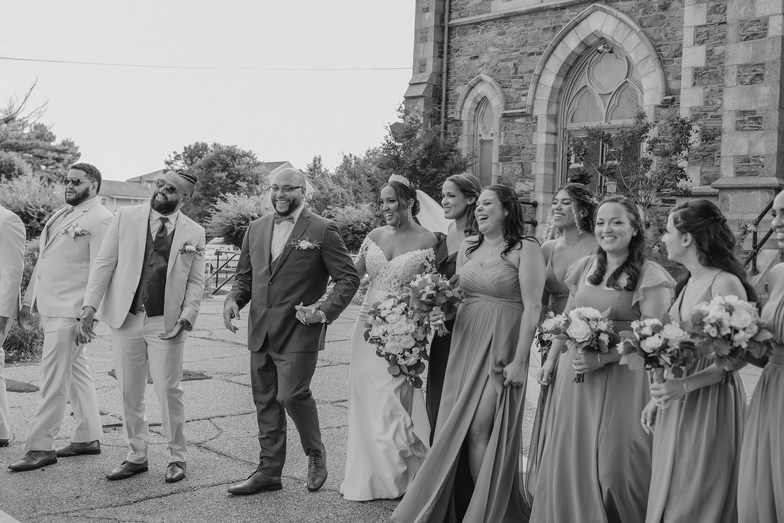 the wedding party poses outside the classy New England church wedding venue