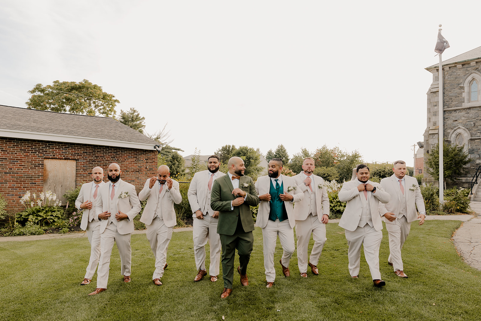 Groom walks with his groomsmen after his classy wedding day 