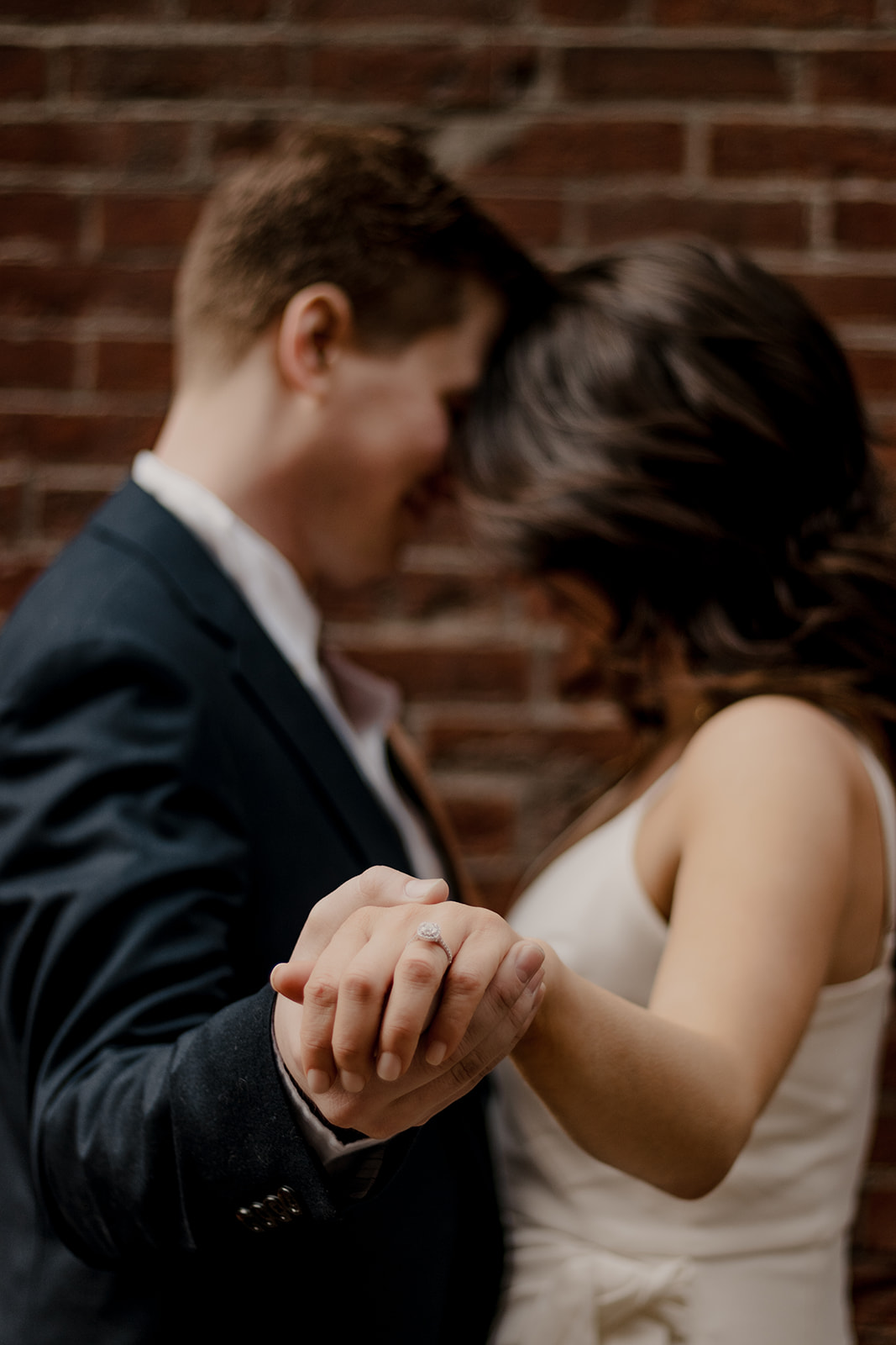 couple walk the streets of Boston taking candid style engagement photos 