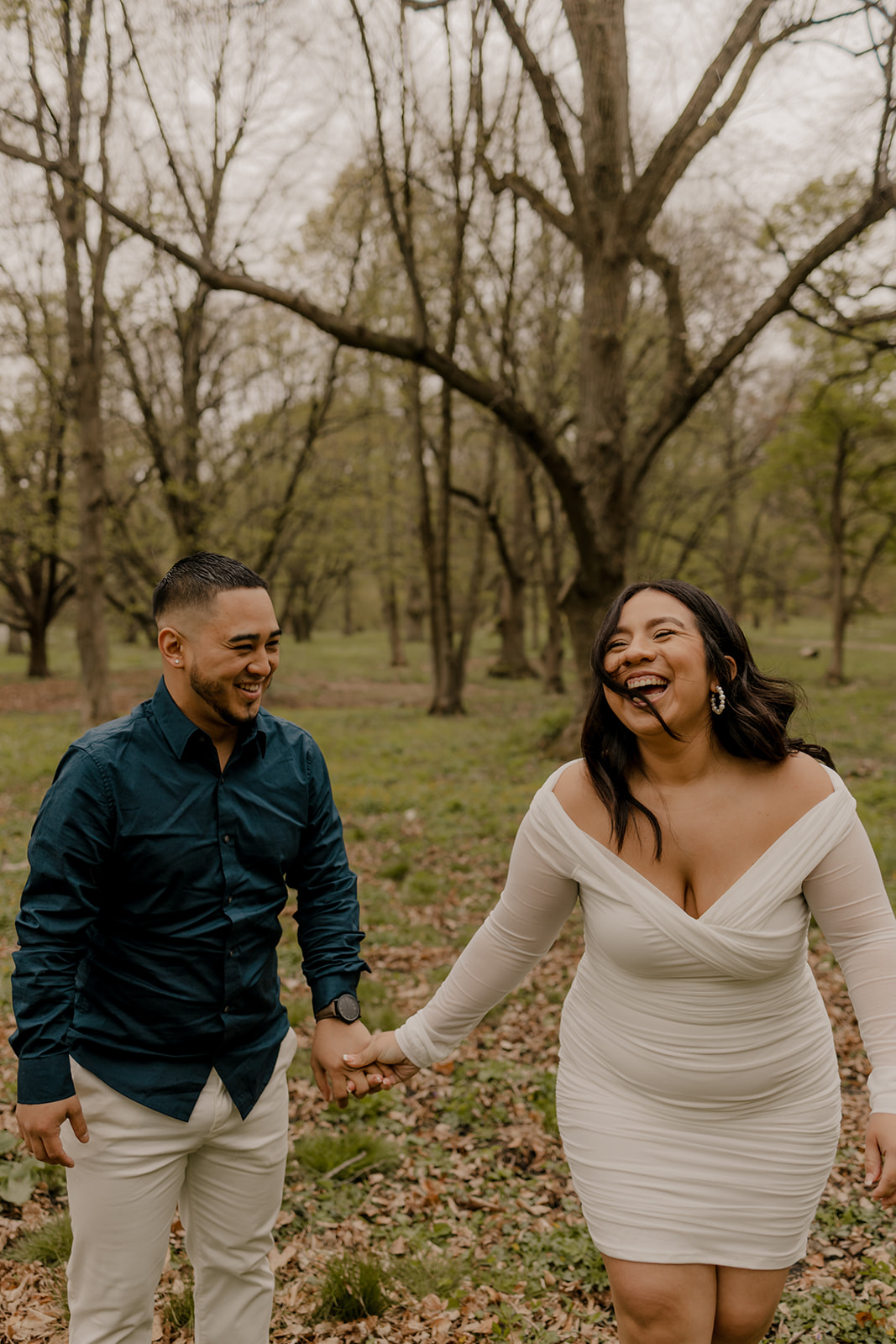 gorgeous couple take candid engagement photos during their Harvard arboretum engagement photos