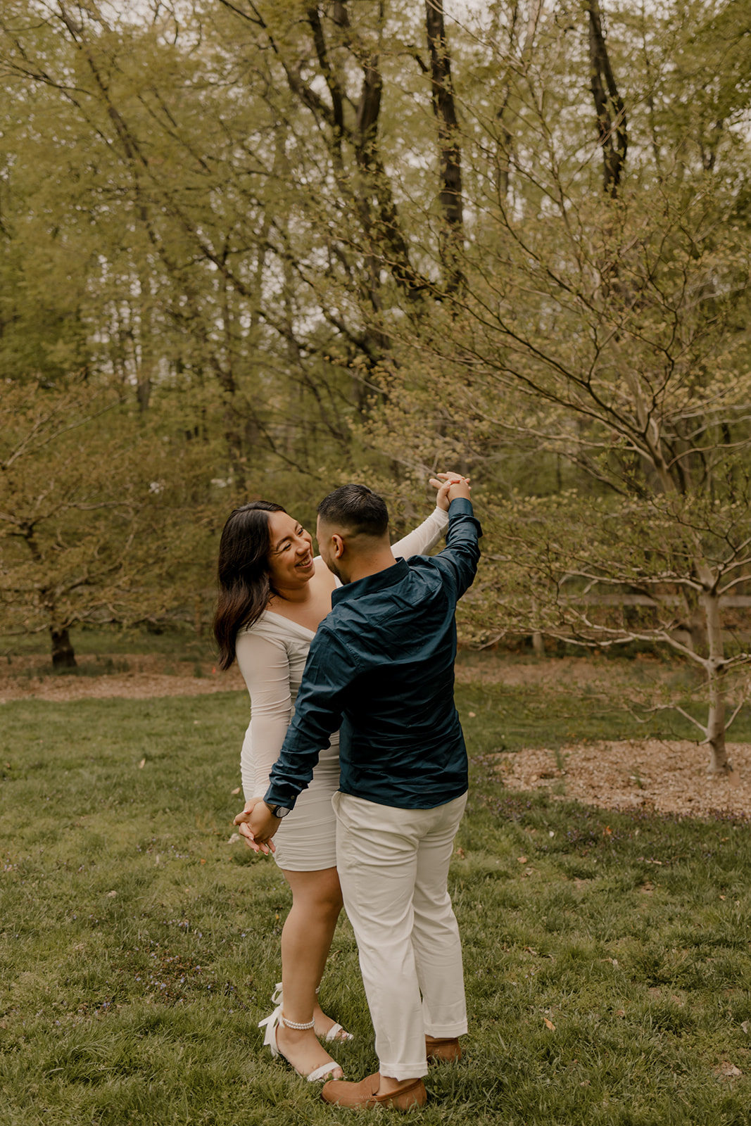 gorgeous couple take candid engagement photos during their Harvard arboretum engagement photos