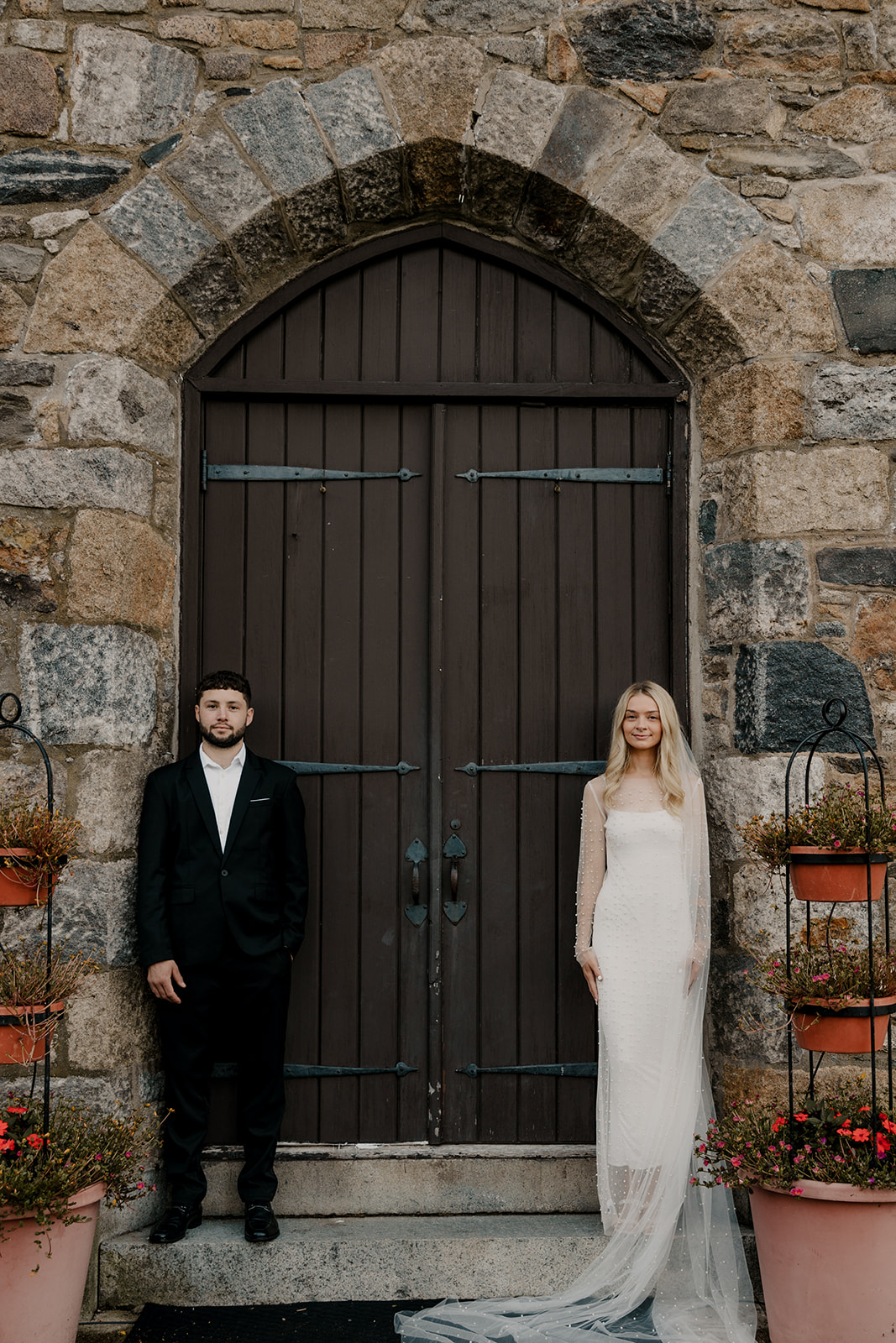 bride and groom pose together during their wedding portraits 