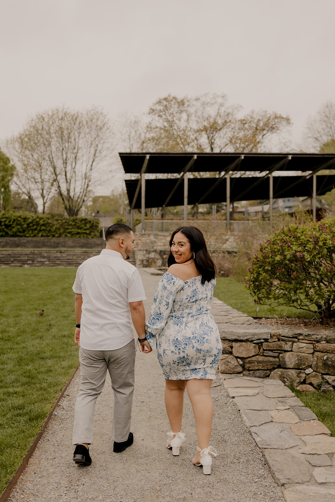 gorgeous couple take candid engagement photos during their Harvard arboretum engagement photos