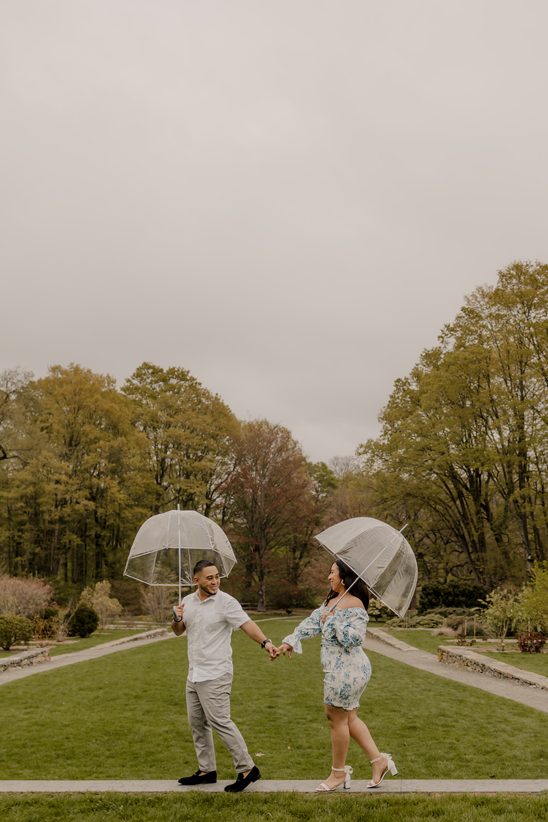 gorgeous couple take candid engagement photos during their Harvard arboretum engagement photos