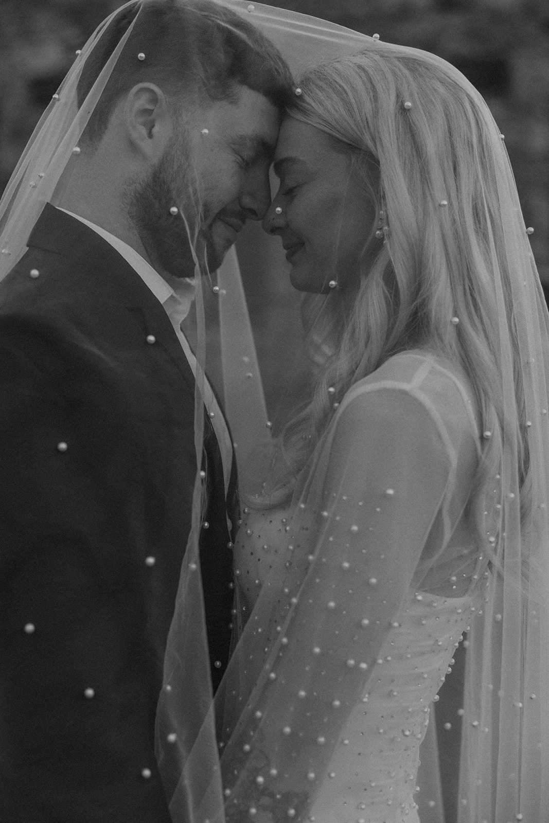 bride and groom pose together during their wedding portraits 