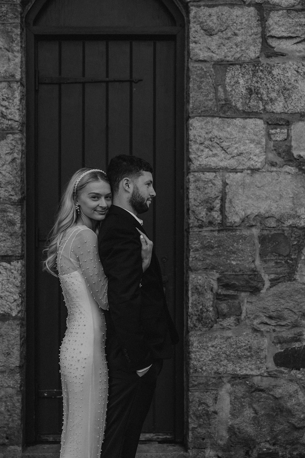 bride and groom pose together during their wedding portraits 