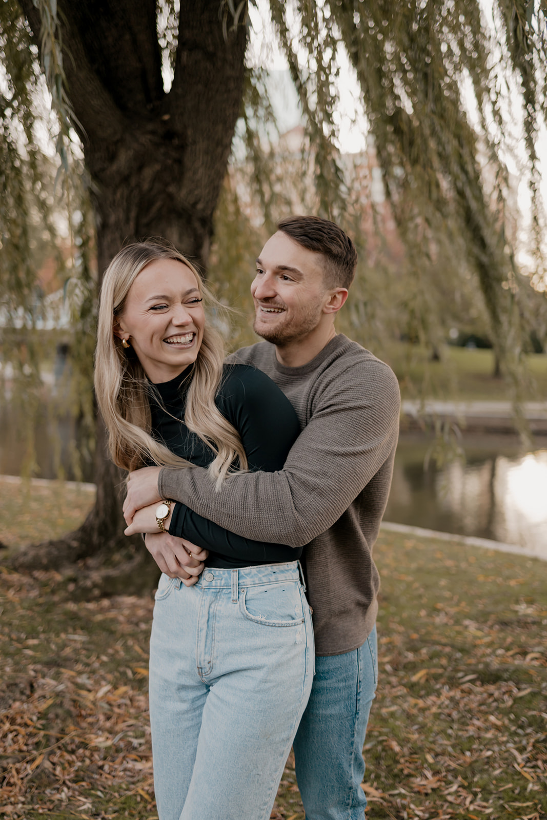 Beautiful couple pose together in a Boston garden, a perfect Boston engagement location