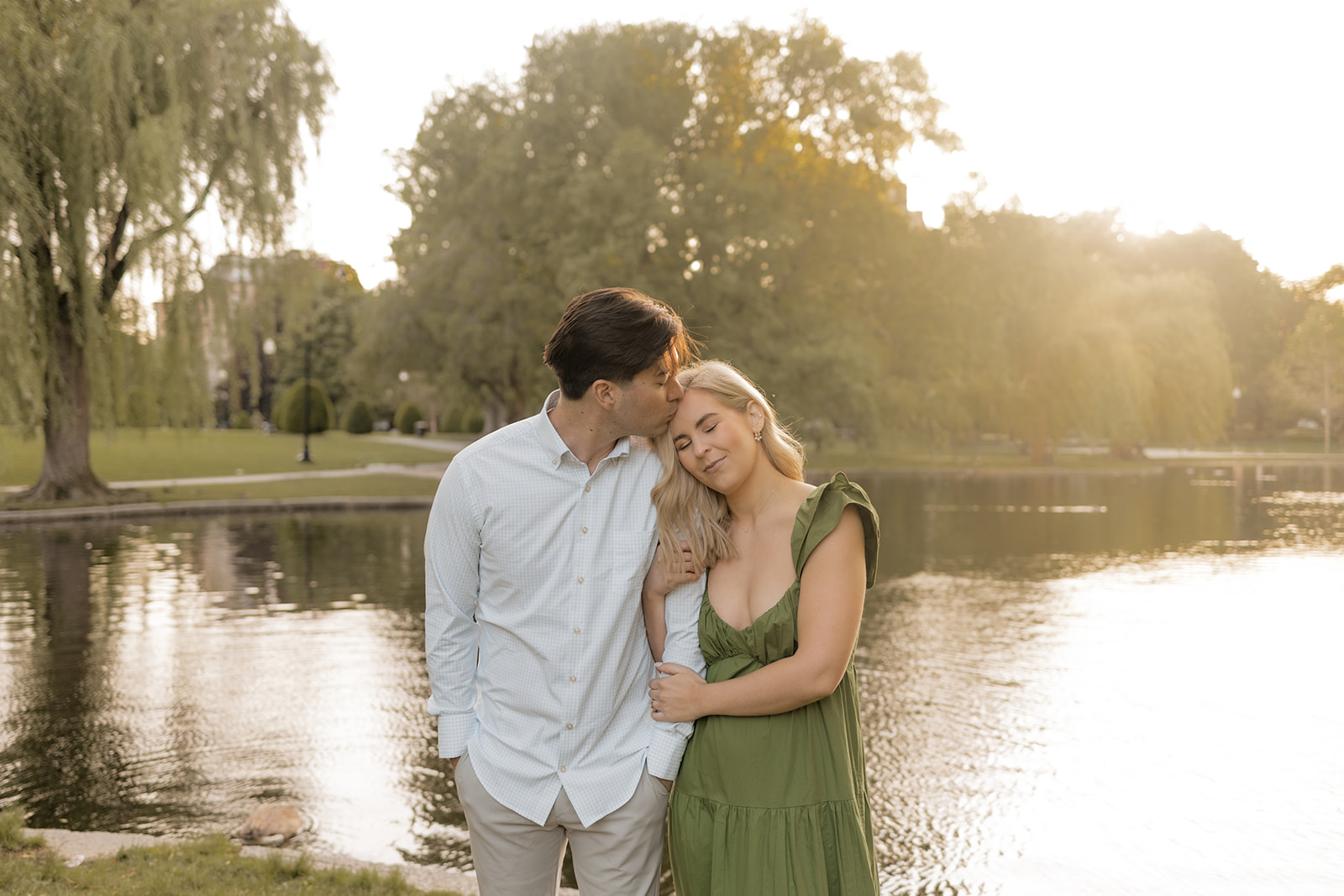 Beautiful couple pose together in a Boston garden, a perfect Boston engagement location