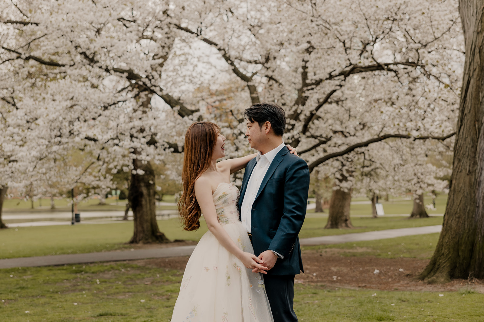 Beautiful couple pose together in a Boston garden, a perfect Boston engagement location