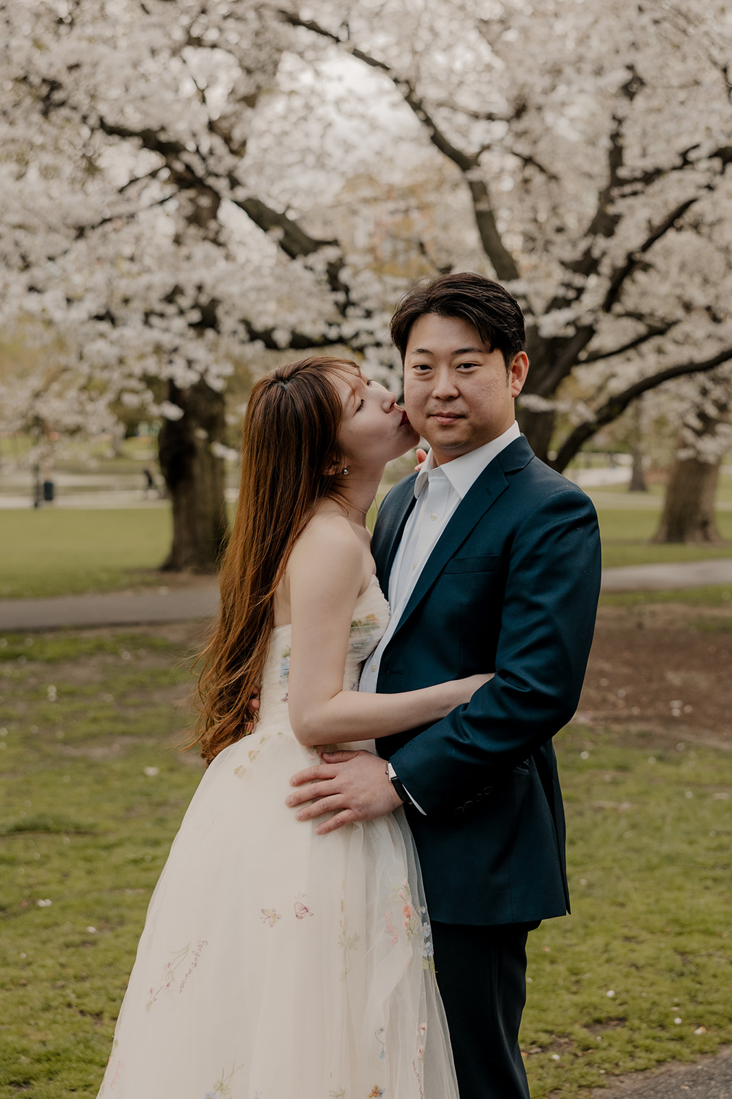 Beautiful couple pose together in a Boston garden, a perfect Boston engagement location