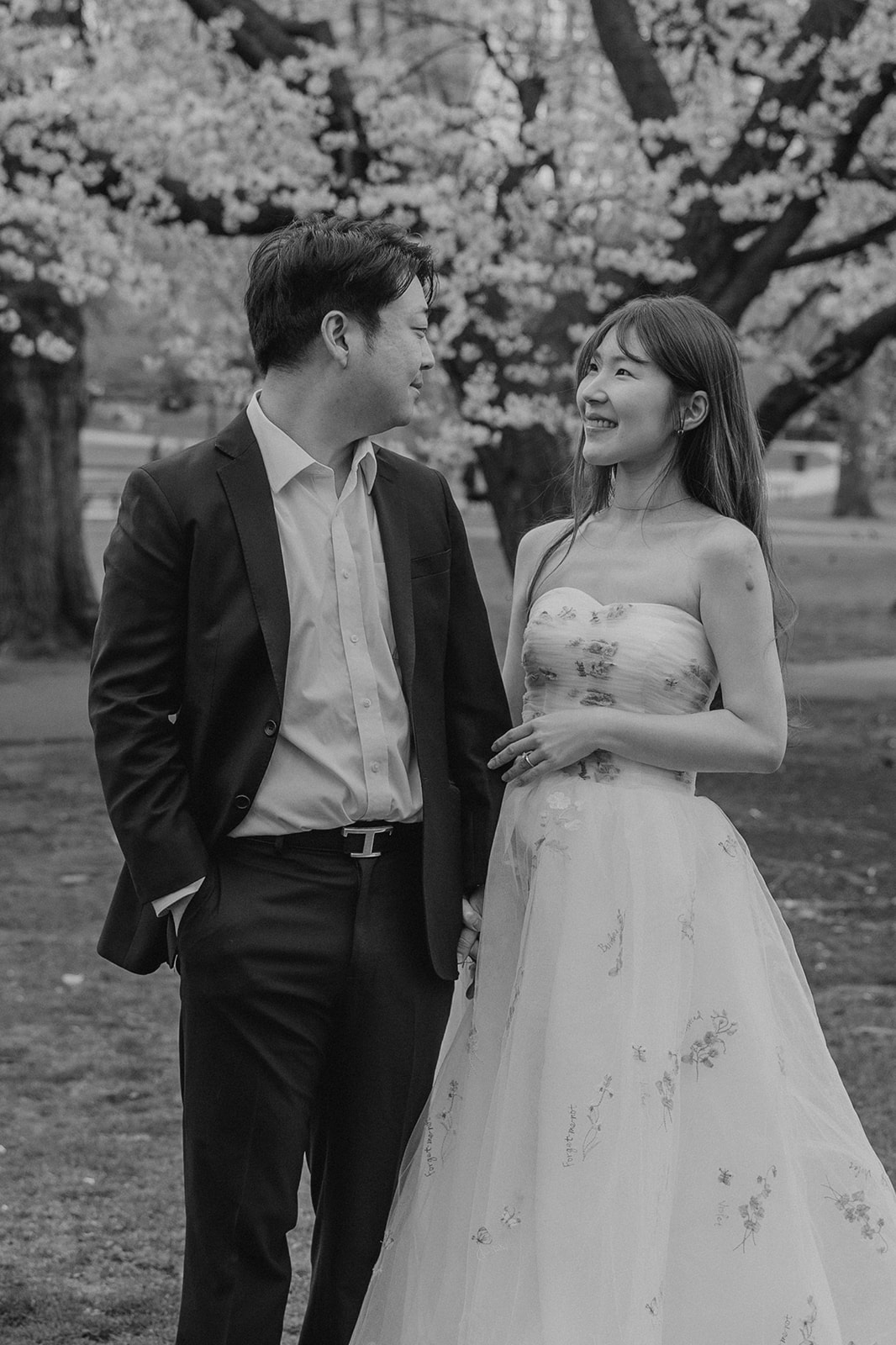 Beautiful couple pose together in a Boston garden, a perfect Boston engagement location