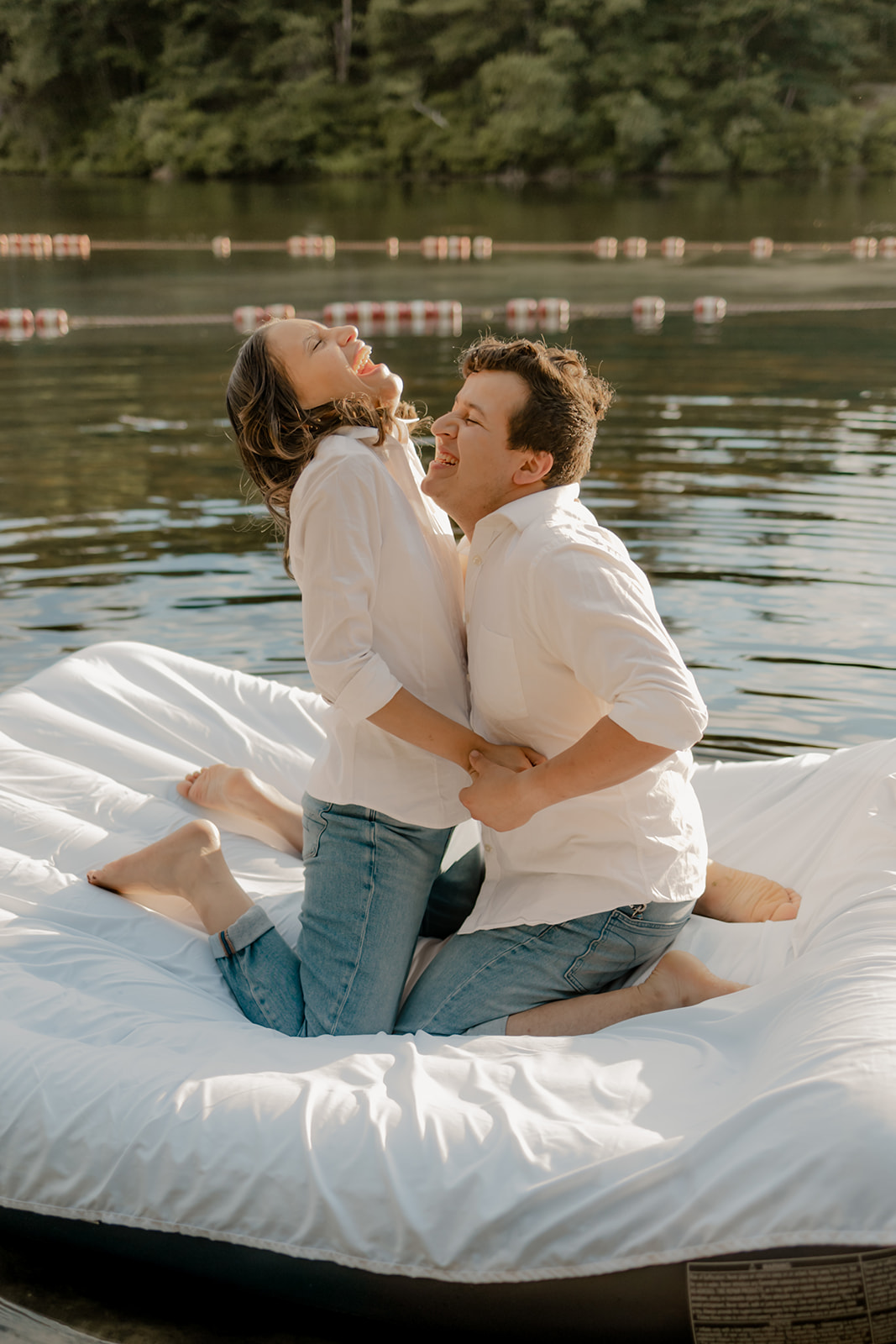 stunning couple pose on an air mattress together