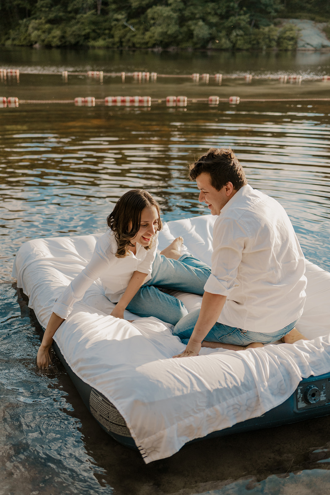 stunning couple pose on an air mattress together